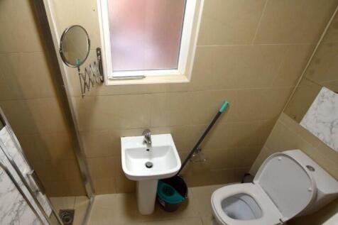 Compact, modern bathroom with a pedestal sink, ...