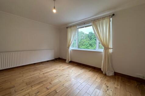 Bright, unfurnished bedroom with wide window ov...