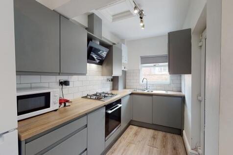 Modern galley kitchen with grey fitted cabinets...