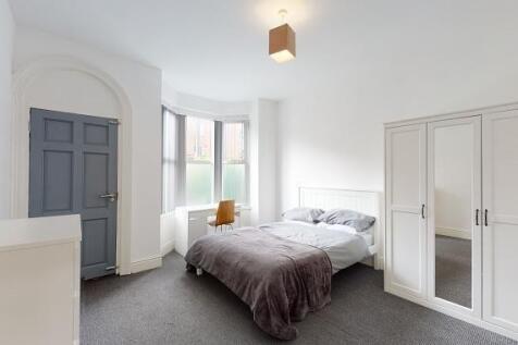 Bright, freshly decorated master bedroom with a...