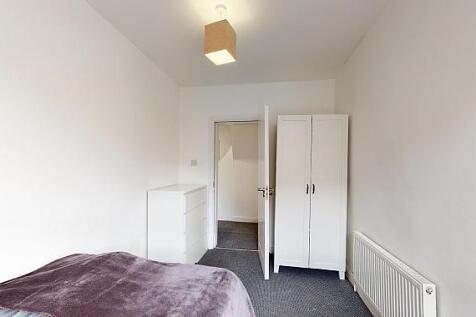 Simple, neutral single bedroom with a fitted wa...