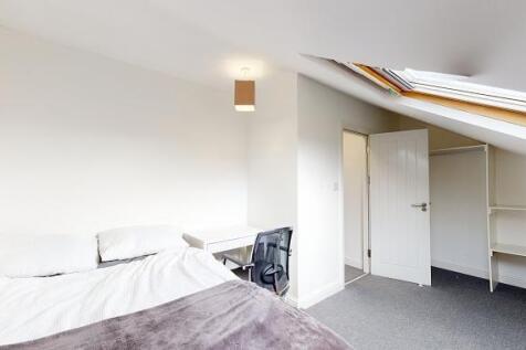 Bright attic double bedroom with a skylight, fi...