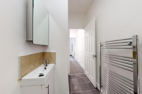 Bright, modern bathroom with a slim basin, mirr...