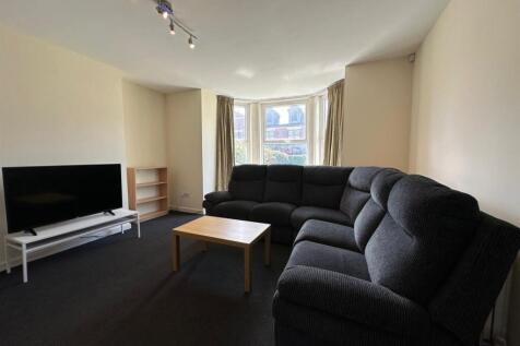 Bright, comfortable living room with a large ba...