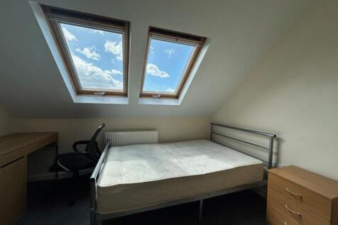Bright attic double bedroom with two skylight w...