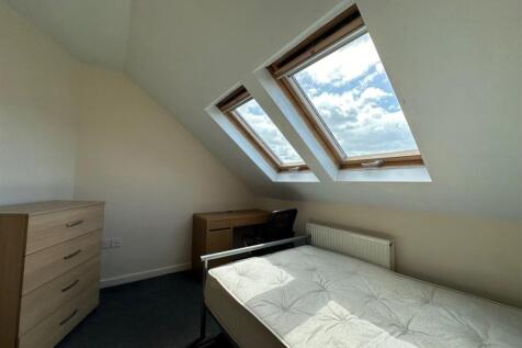 Bright attic single bedroom with two large skyl...