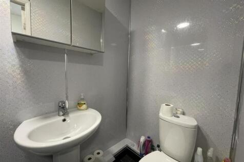 Bright, modern bathroom with a clean white basi...