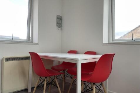 Bright, minimal dining nook with a white table ...