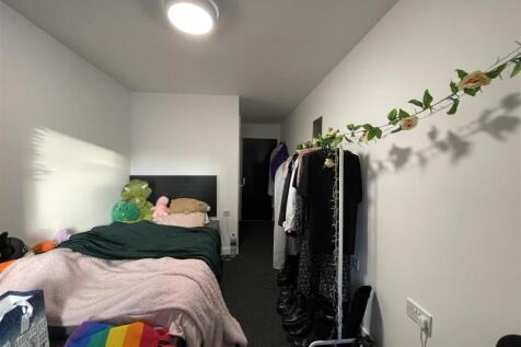 Neat single bedroom with a comfortable bed, sof...