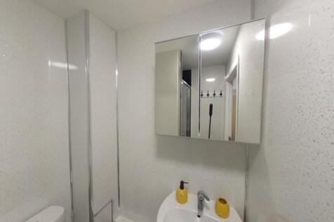 Bright, modern bathroom with a clean white sink...