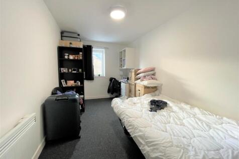 Bright, simply furnished single bedroom with a ...