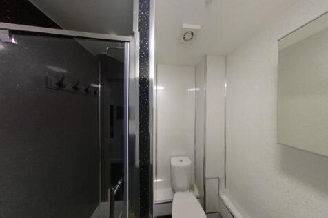 Modern white bathroom with a shower cubicle, to...