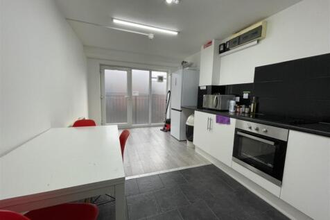 Bright modern kitchen with integrated oven, fri...