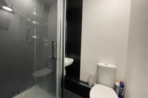 Modern bathroom with a walk-in shower, compact ...