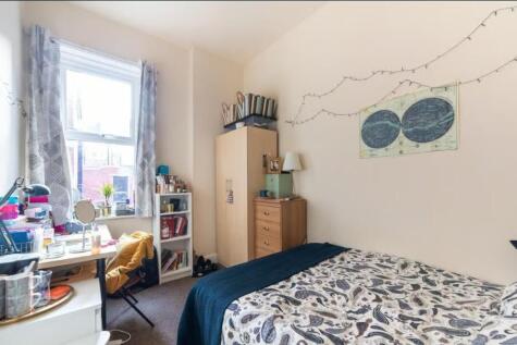 Bright, neatly arranged double bedroom with a p...