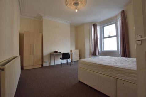 Bright, well-proportioned bedroom with a large ...