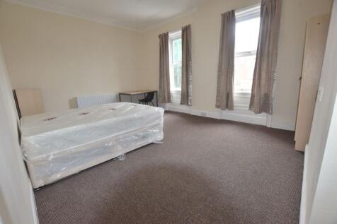 Bright, well-proportioned bedroom with two tall...