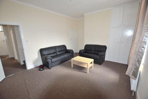 Bright furnished living room with two comfy lea...