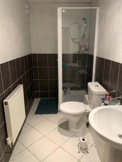A compact, well-maintained bathroom with a show...