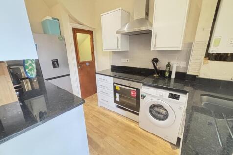 A modern, well-maintained kitchen featuring whi...