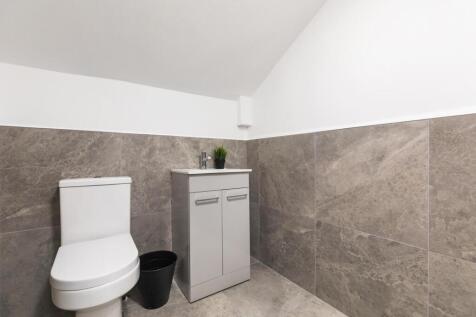 A clean and modern bathroom featuring a spaciou...