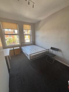 A bright, neatly maintained bedroom featuring t...