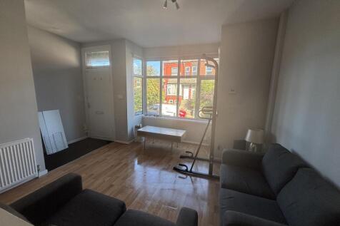 Bright and spacious living room with large wind...