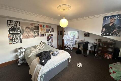 A spacious and well-lit living room featuring c...