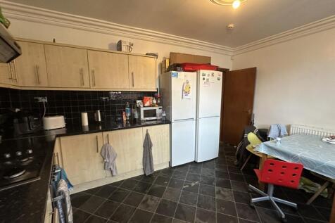 A spacious and well-maintained kitchen featurin...