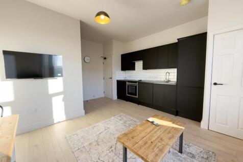 Bright open-plan kitchen-living space with mode...