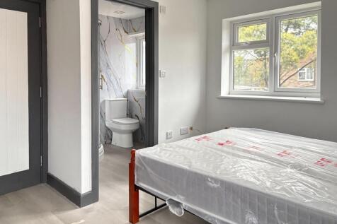 Bright, well-presented bedroom with a large win...