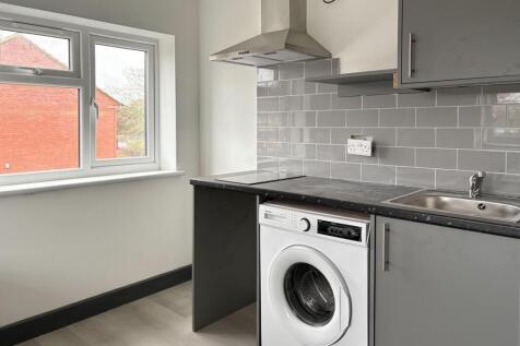 Modern compact kitchen with fitted grey cabinet...