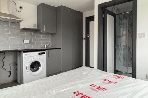 Bright, modern studio bedroom with integrated k...