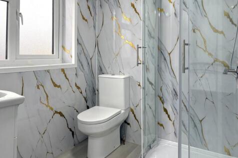 Modern bathroom with marble-effect wall tiles, ...