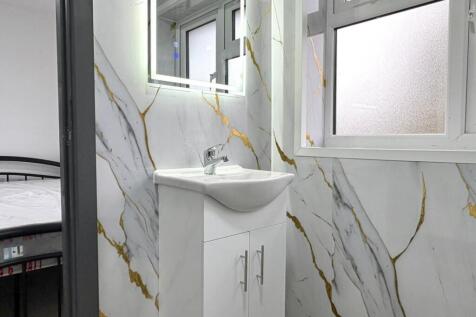 Bright, modern bathroom with sleek white vanity...