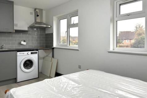 Bright, simply styled bedroom with fresh neutra...