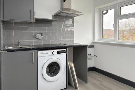 Compact modern kitchen with grey cabinetry, int...