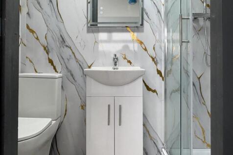 Contemporary bathroom with marble-effect wall t...