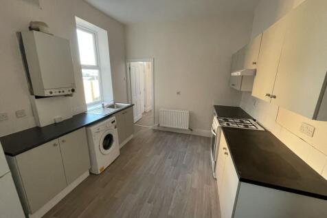 Bright galley kitchen with long worktops either...