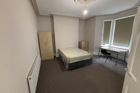 A spacious and well-lit double bedroom perfect ...