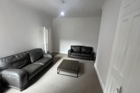 Bright neutral living room with two comfortable...