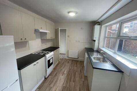 Bright, modern galley kitchen with large window...