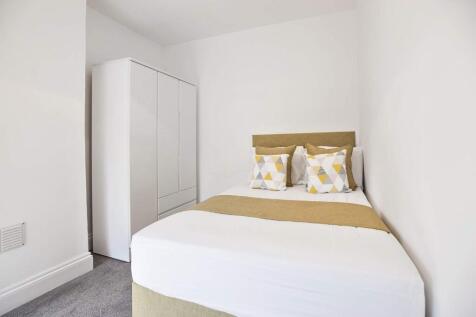 Bright, neatly presented bedroom with a comfort...