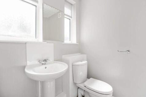 Bright, modern bathroom with white sanitaryware...