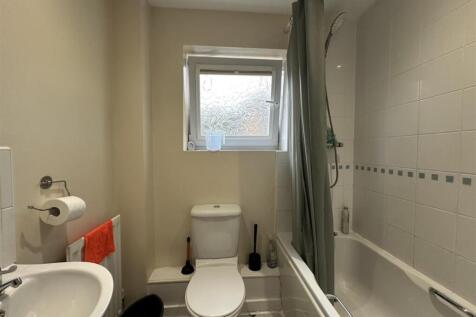 Well-kept bathroom with a bath and shower, fros...