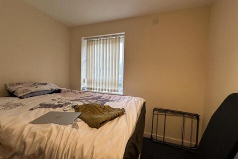 Bright, neutrally decorated double bedroom with...