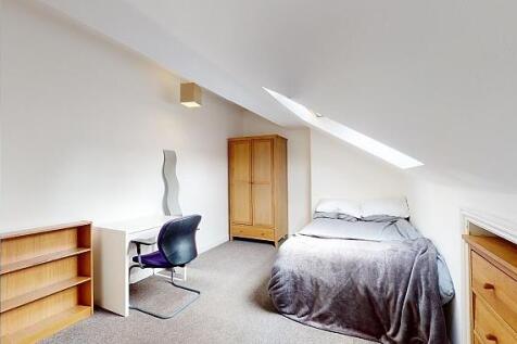 Bright attic bedroom with a skylight, cosy sing...
