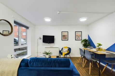 A spacious and inviting modern living room, per...