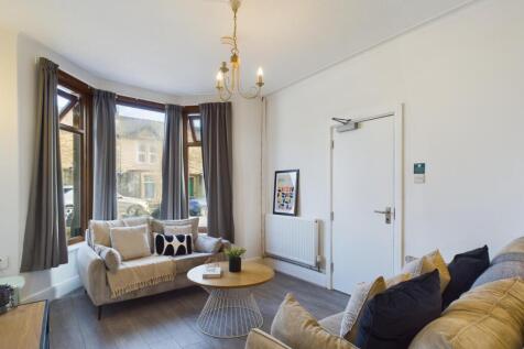 A bright and inviting large modern living room,...