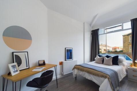 A bright and stylish double bedroom featuring a...